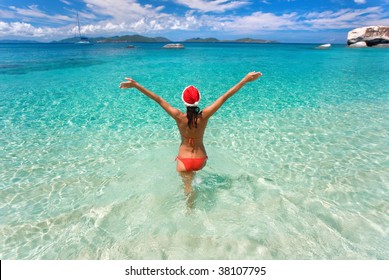 Woman On Tropical Beach With Christmas Hat