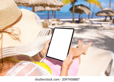 Woman On Tropical Beach Holding Tablet In Vertical Screen Orientation, Blank Tablet's Screen Mockup