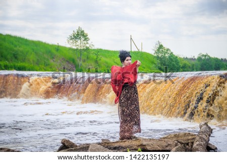 Woman on the waterfalls. Little waterfall. Camping. . Young woman. Woman in a dress.