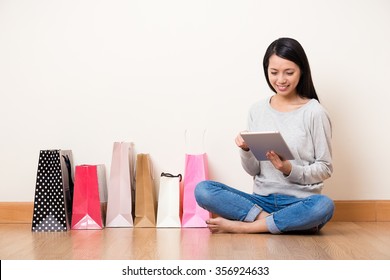 Woman online shopping though tablet pc - Powered by Shutterstock