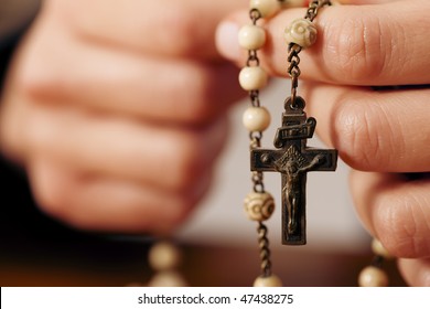 Woman (only Closeup Of Hands To Be Seen) With Rosary Sending A Prayer To God, The Dark Setting Suggests She Is Sad Or Lonely