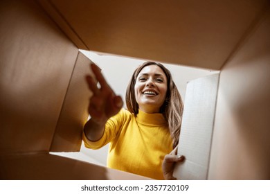 Woman with open box,view from inside.Excited girl unboxing cardboard delivery package. - Powered by Shutterstock