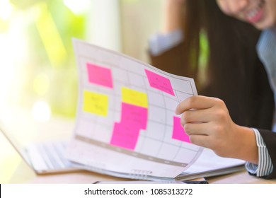 Woman Open Calendar For Checking Available Time To Reserve Appointments. Busy Schedule With Colorful Notepad On Calendar Paper With Fully Booked. Planner
Has Got A Headache To Manage Tight Schedule.
