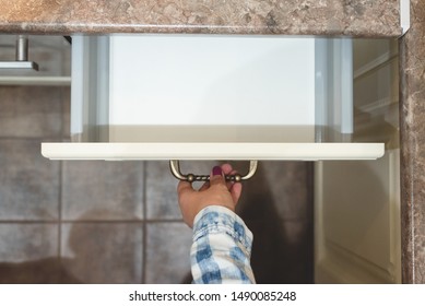 Woman Open Empty Kitchen Drawer For Cutlery With A Copy Space. Customer Is Choosing A New Kitchen Set Furniture.