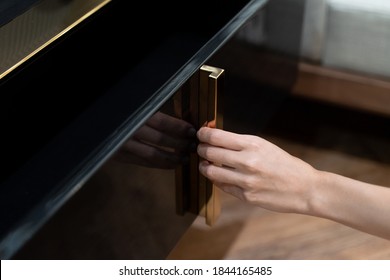 Woman Open Shelf, Pull Open Drawer In On Black Cabinet.