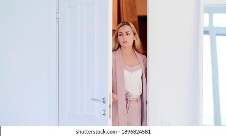 Woman opening door. tired woman enters a room or her apartment after a hard day at work