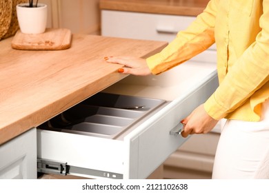 Woman Opening Drawer In Kitchen, Closeup