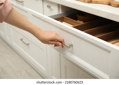 Woman Opening Drawer In Kitchen, Closeup View