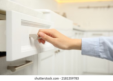 Woman Opening Drawer In Kitchen, Closeup View