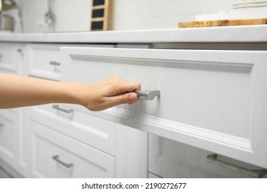 Woman Opening Drawer In Kitchen, Closeup View