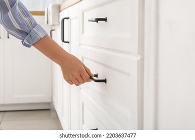 Woman Opening Drawer In Light Kitchen, Closeup