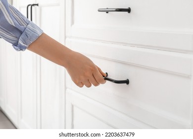 Woman Opening Drawer In Light Kitchen, Closeup