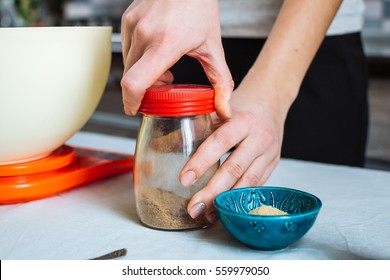 Woman Opening A Jar With Spice