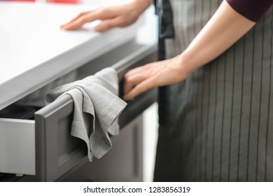 Woman Opening Kitchen Drawer, Closeup