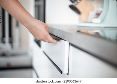 Woman Opening Kitchen Top Drawer