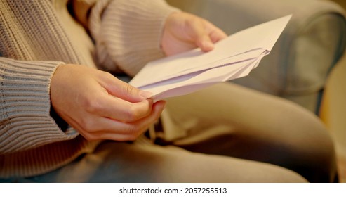 A Woman Is Opening A Letter