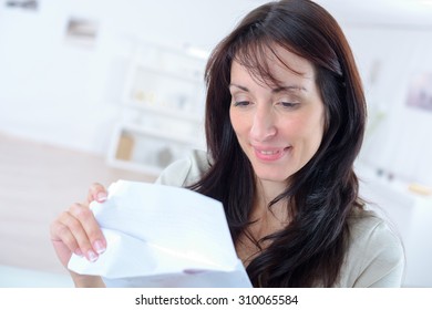 Woman opening a letter