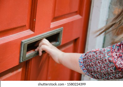 Woman Opening The Letter Hole On The Doors, Mailbox, Letter Plate In The UK