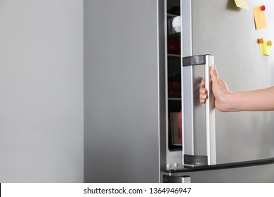 Woman Opening Modern Fridge