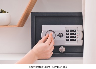 Woman opening modern safe indoors - Shutterstock ID 1891124866