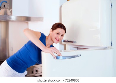 Woman Opening The Refrigerator