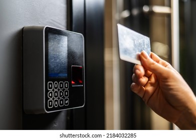 A woman opens the door with a plastic card. Modern keyless entry lock.  - Shutterstock ID 2184032285