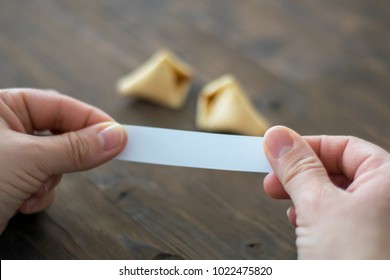 Woman opens a fortune cookie