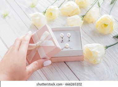 Woman Opens A Gift Box With Jewellery