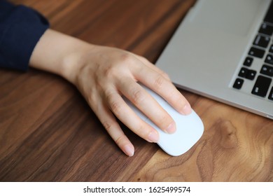 Woman Operating A Bluetooth Mouse
