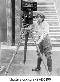 Woman operating movie camera