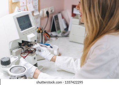 woman ophthalmologist working in optics store