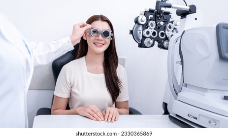 Woman optical shop customer doing eyesight measurement with optical phoropter check eye distance for eyeglasses is optical  eye shop service. - Powered by Shutterstock