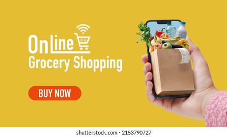 Woman ordering her grocery online, she is holding a smartphone with a small grocery bag full of goods, banner with copy space - Shutterstock ID 2153790727