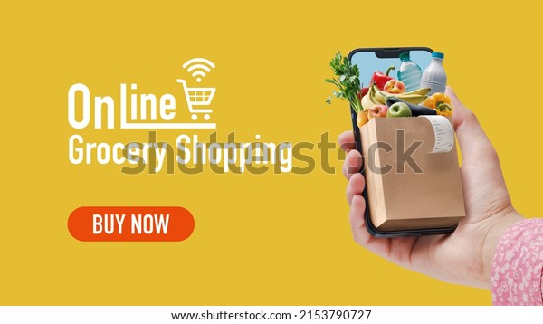 Woman ordering her grocery online, she is holding a\
smartphone with a small grocery bag full of goods, banner with copy\
space