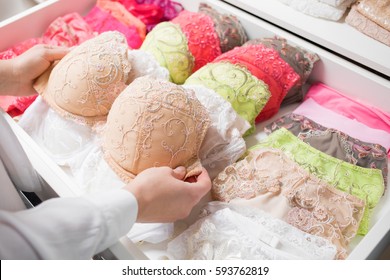 Woman Organizing Underwear In Drawer