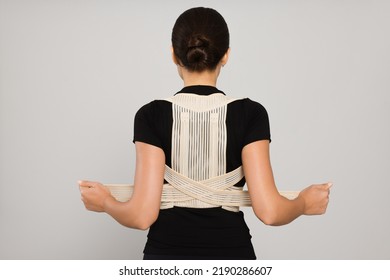 Woman With Orthopedic Corset On Grey Background, Back View