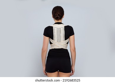 Woman With Orthopedic Corset On Grey Background, Back View