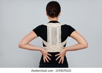 Woman With Orthopedic Corset On Grey Background, Back View