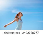 Woman, outdoor and happy with arms open for meditation or freedom to relax, break and mental health. Female person, stress relief and happy with yoga or balance for wellness, wellbeing and self care