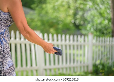 Woman Outside Tossing A Cornhole Game Bag - Soft Focus