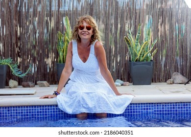 Woman Over 50 Years Old With White Dress In Pool