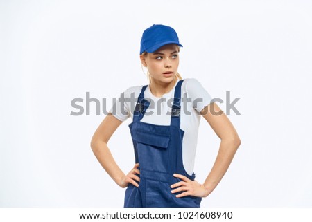woman in overalls, cap on a light background, delivery, cargo, transportation                               
