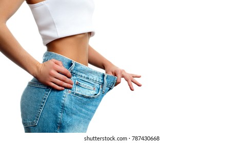 Woman In Oversize Jeans After Weight Loss, Diet Concept. 