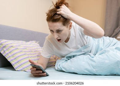 Woman Overslept And Looks At The Time On Her Smartphone In Shock. Middle-aged Woman Is Late Due To Late Awakening. The Alarm Did Not Go Off On The Smartphone.