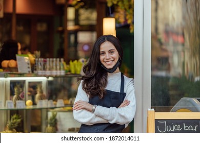 Woman, Owner Of Restaurant In The Background.