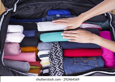 A Woman Packing A Luggage For A New Journey 