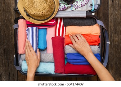 woman packing a luggage for a new journey