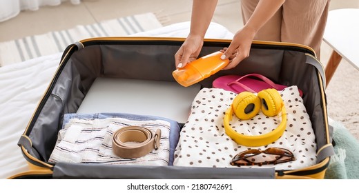 Woman Packing Suitcase At Home. Travel Concept