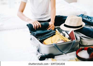 Woman packing travel bag for summer vacation. Tourism and objects concept, suitcase for summer holidays