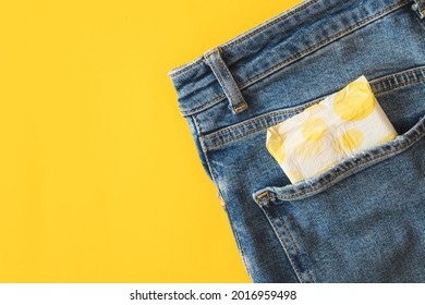 Woman Pad In The Pocket Of Denim Pants.